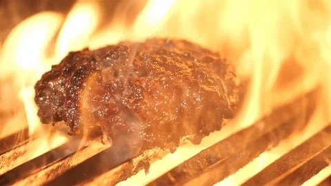 Tasty beef burger flipping on the grill Stock Footage