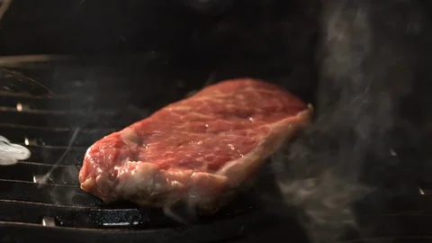 Tasty beef steaks on the grill with fire flames Stock Footage 111649234