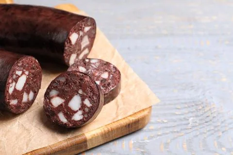 Tasty blood sausage on grey wooden table, closeup. Space for text Stock Photos