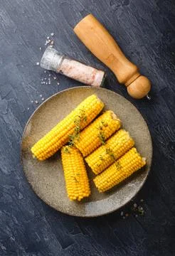 Tasty boiled corn cobs on plate Stock Photos