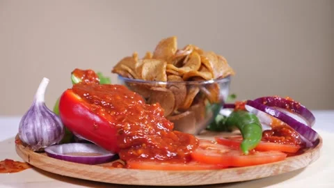 Tasty bread crackers with onion, pepper and tomato sauce on a wooden plate Stock Footage 124379389