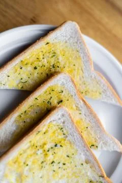 Tasty bread with garlic  on kitchen table. Stock Photos