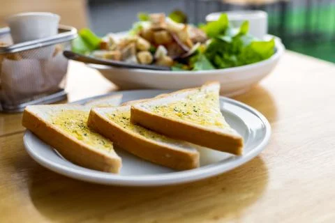 Tasty bread with garlic  on kitchen table. Stock Photos