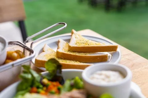 Tasty bread with garlic  on kitchen table. Stock Photos