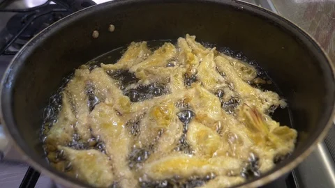 Tasty breaded cod frying in a pan Stock Footage 91047361