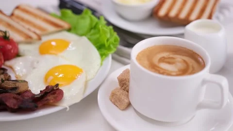 Tasty breakfast - cherry tomatoes, fried mushrooms, bacon and eggs on white Stock Footage 210388152