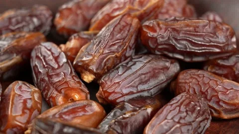 Tasty brown dried dates fruit isolated on brown background Stock Footage 155873718