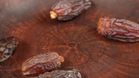 Tasty brown dried dates fruit isolated on brown background Stock Footage 161346414