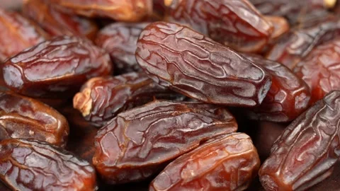 Tasty brown dried dates fruit isolated on brown background Stock Footage 161346425