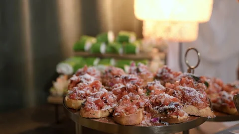 Tasty buffet table with assorted gourmet appetizers displayed neatly o Stock-Footage 327566210