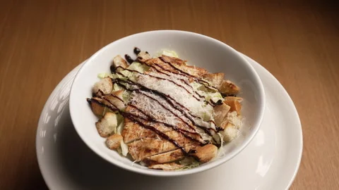 Tasty caesar salad with grilled chicken, croutons, and parmesan cheese Stock Footage 336716554