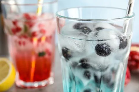 Tasty cocktail with blueberry ice cubes on table, closeup Stock Photos