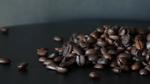 Tasty coffee grounds moving around on turn table, on white background, view from Stock Footage 243295935