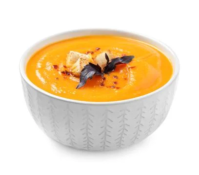 Tasty creamy pumpkin soup in bowl on white background Stock Photos