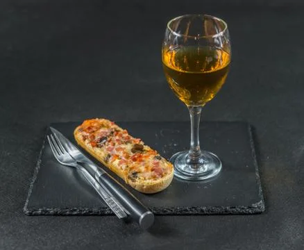 Tasty crispy bread with melted cheese, pepperoni, ham, mushrooms, red onion Stock Photos