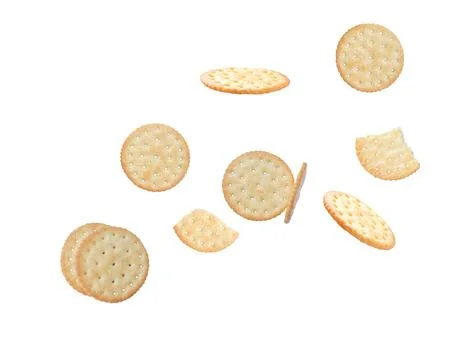 Tasty crispy round crackers falling isolated on white background Stock Photos