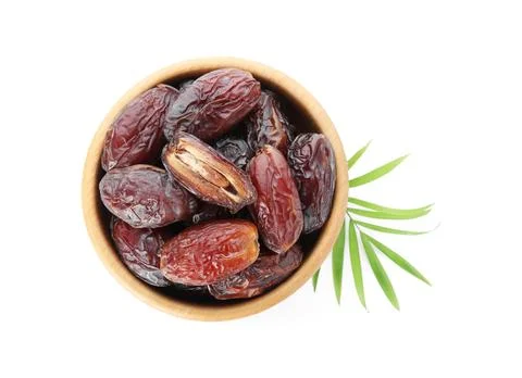 Tasty dried dates and leaf in bowl isolated on white, top view 스톡 사진