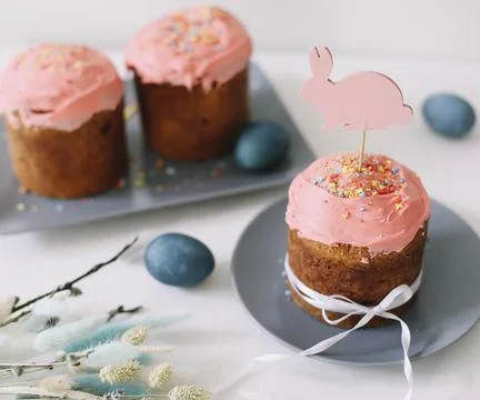 Tasty Easter cake, painted eggs, willow branches and toy bunny on table top view Stock Photos