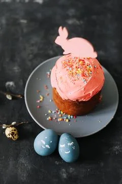 Tasty Easter cake, painted eggs, willow branches and toy bunny on table top view Stock Photos