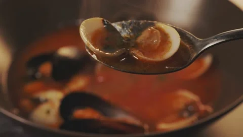 Tasty fish soup boiling. Taking a spoonful of  Mediterranean fish soup with muss Stock Footage 235149399