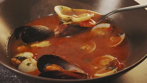 Tasty fish soup boiling. Taking a spoonful of  Mediterranean fish soup with muss Stock Footage 235149604