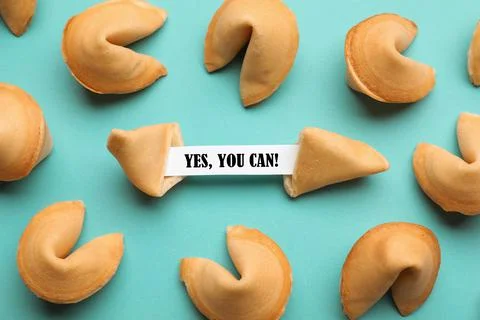 Tasty fortune cookies with prediction Yes, you can! on cyan background, above Stock Photos