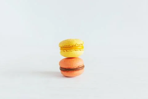 Tasty french macaroons on a white wooden background.  Place for text. Stock Photos