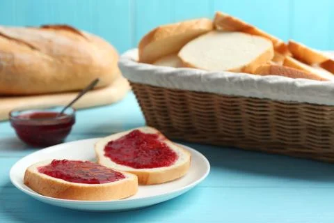 Tasty fresh bread with jam on light blue wooden table Stock Photos