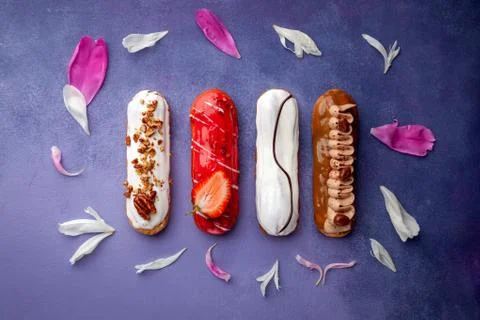 Tasty glazed eclair set, chocolate, strawberry, nuts, cream Stock Photos
