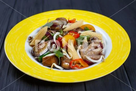 Tasty grilled vegetables mix with soybean sprouts and octopus, c Stock Photos