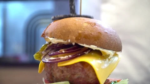 Tasty hamburger with big meat on the wooden table Stock Footage