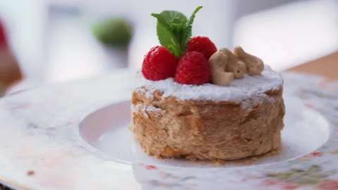 Tasty honey cake decorated with raspberry and cashew Stock Footage 146377215