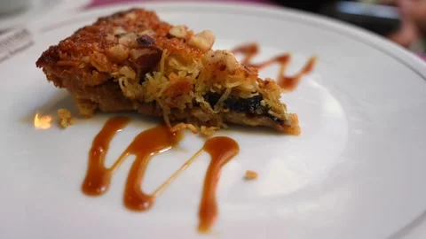 Tasty Looking Piece of Pie with Caramel, Nuts and Coconut. Isolated. Close Stock Footage 282440302