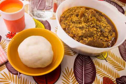 A tasty meal of Pounded yam and Egusi soup in a large white bowl Stock Photos