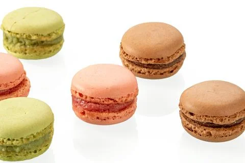 Tasty multi-colored macaroons on a white background close-up Stock Photos
