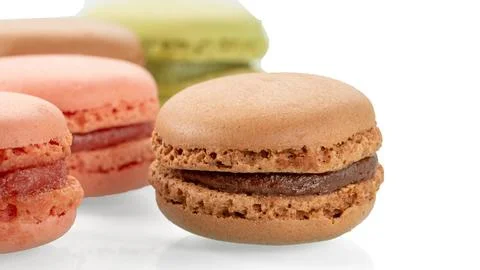 Tasty multi-colored macaroons on a white background close-up Stock Photos