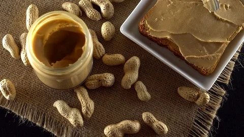 Tasty peanut butter being spread on white toast 動画素材 71371153
