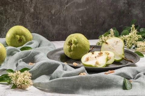 Tasty pears with nuts. A table decorated with flowers and a plate of pears .. Stock Photos