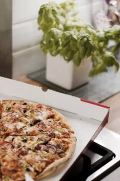 Tasty pizza in the kitchen Stock Photos