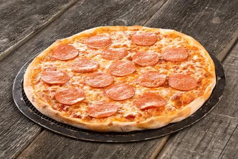 Tasty pizza on the old surface Stock Photos