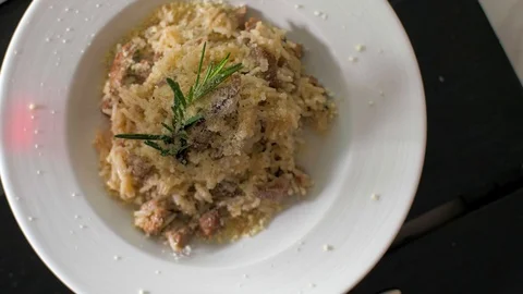 Tasty risotto with veal fillet prepared for two Stock Footage 106935433