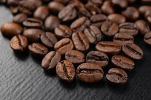 Tasty roasted coffee beans on the table. Black coffee beans straight from the 스톡 사진