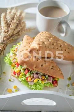 Tasty sandwich with salad, pepper, lettuce, corn, and ham Stock Photos