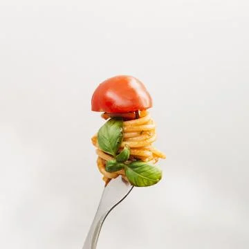 Tasty spaghetti wrapped around fork Stock Photos