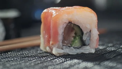 Tasty sushi roll filled with avocado raw salmon ,tuna. Sushi with fish Stock-Footage 153699343