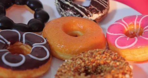 Tasty sweet different colored donuts Vídeo Stock 148622830
