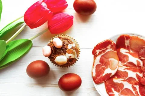 Tasty sweet homemade Easter cake, tulips and eggs, top view Stock Photos
