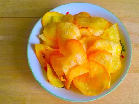 Tasty tapioca chips in a bowl on the table Stock Photos