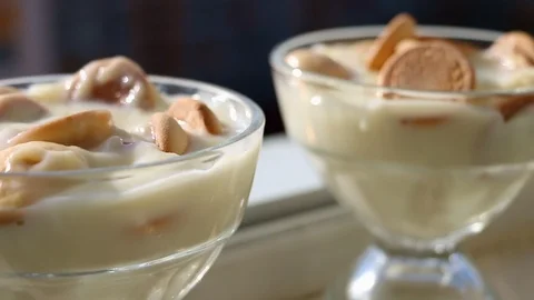 Tasty vanilla pudding with biscuits in two glass cups Stock Footage 124434348