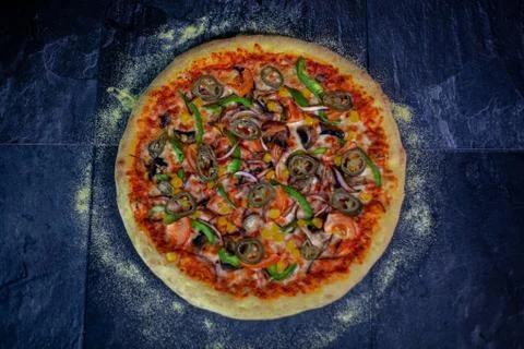 Tasty vegetarian pizza over a rustic background Stock Photos